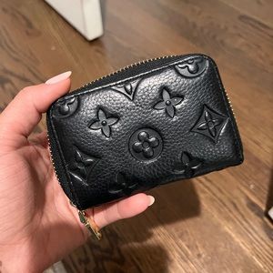 Black imprint with gold hardware accordion style card wallet.